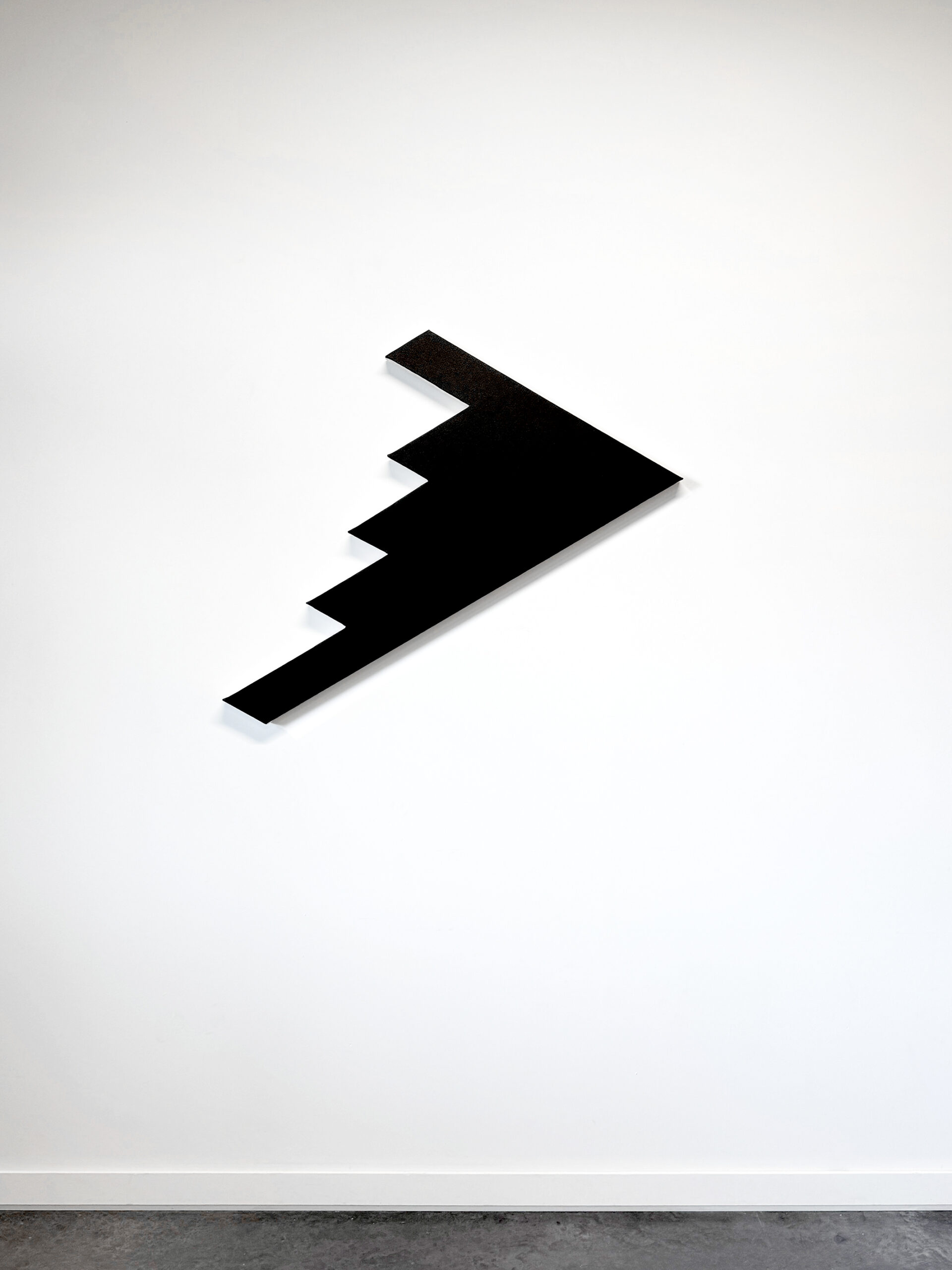 Jean-Charles Kien's geometric black shaped canvas artwork B2S2 hanging on a white gallery wall