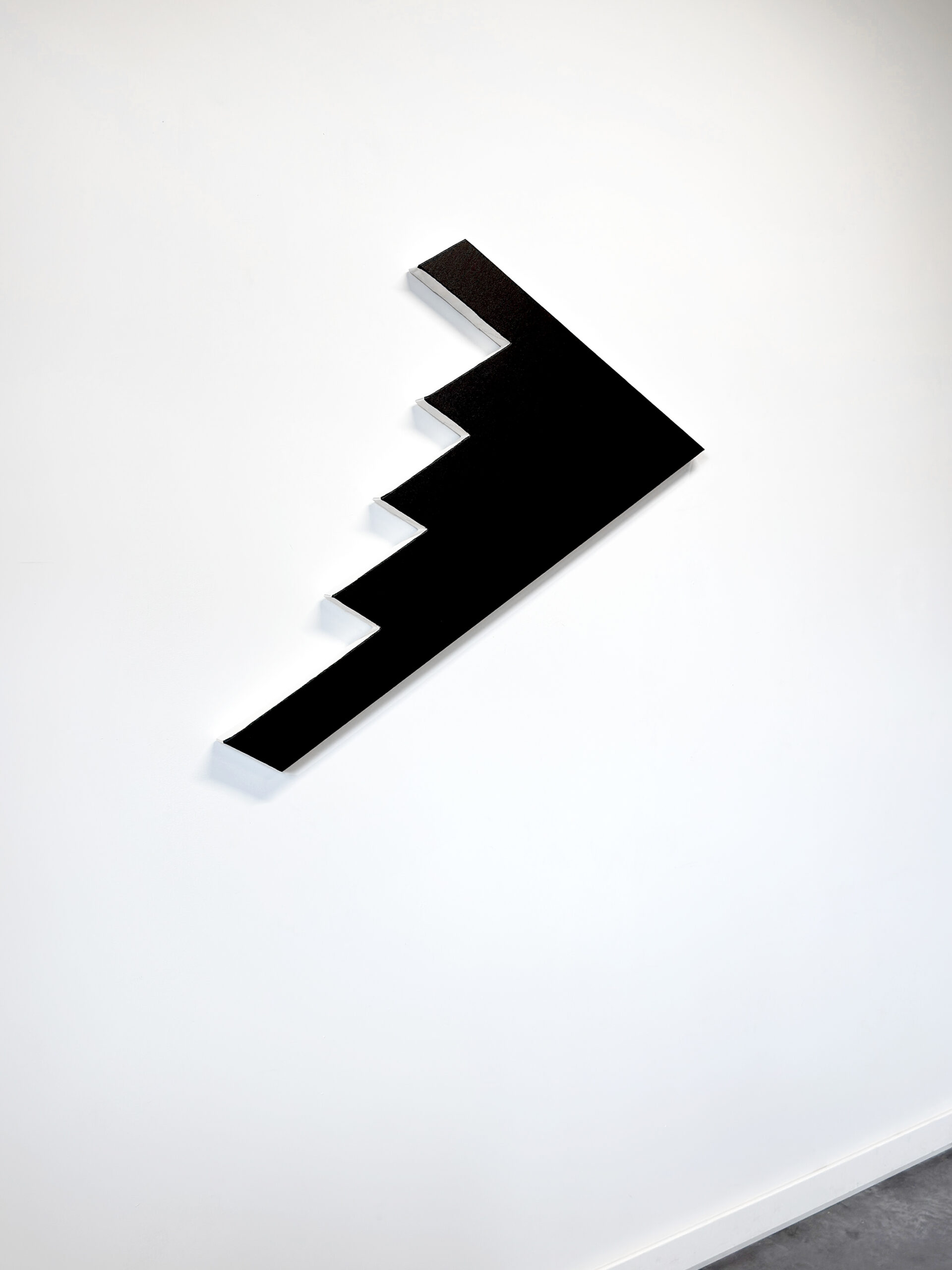 Angled perspective view of black geometric painting B2S2 by Jean-Charles Kien on a white wall