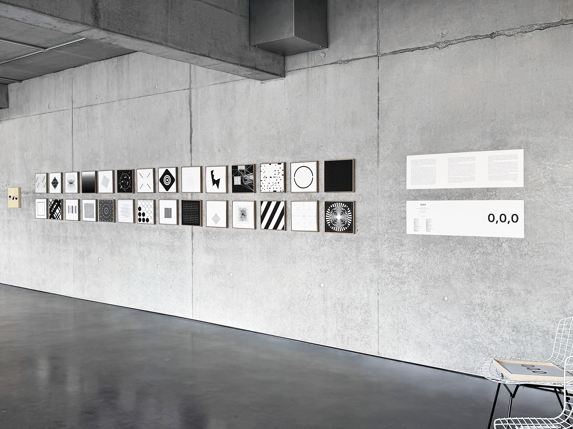 Exhibition view of the 0,0,0 portfolio on a concrete wall, featuring 30 abstract artworks including Jean-Charles Kien