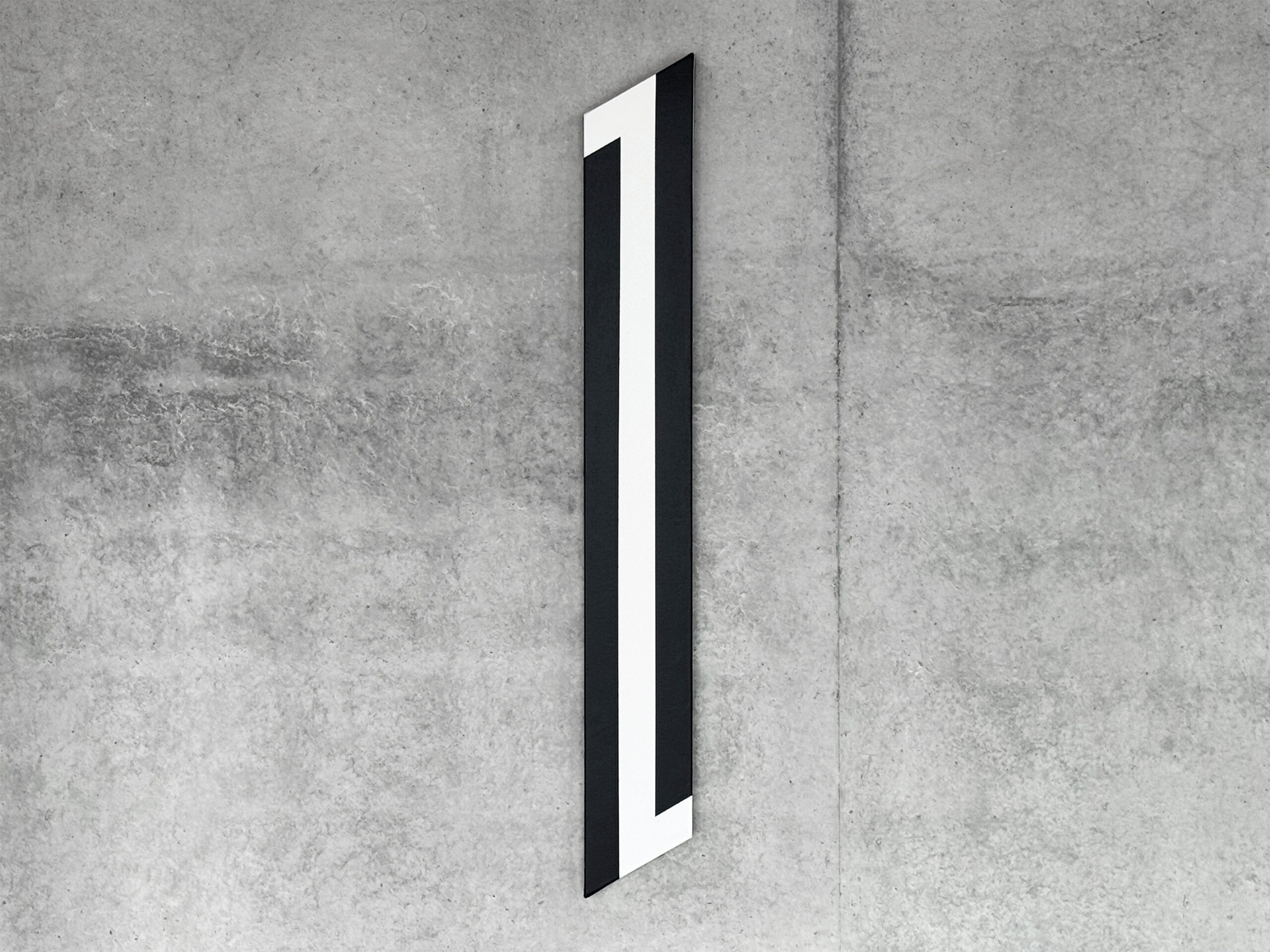 Perspective view of an elongated vertical geometric painting by Jean-Charles Kien on concrete.