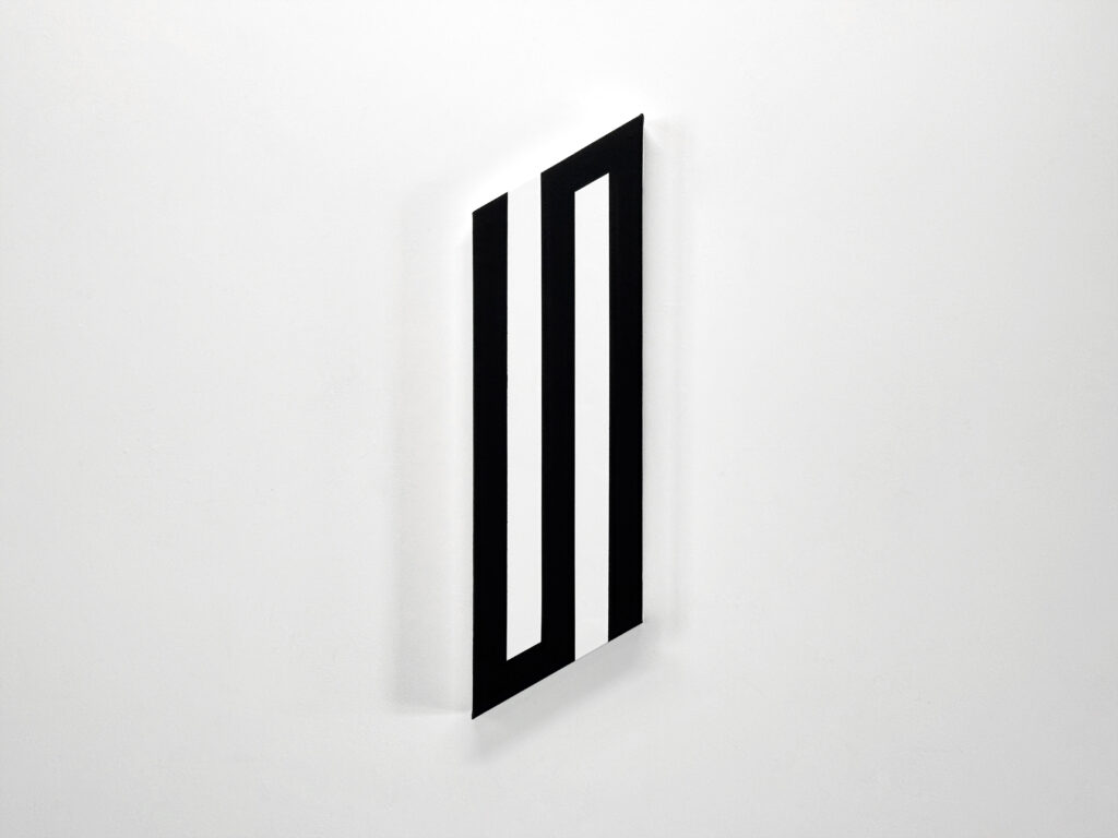 Perspective view of an elongated vertical shaped canvas painting by Jean-Charles Kien on a gallery wall.